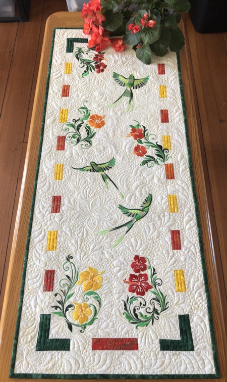Finished tablerunner with embroidery of birds and blooming hibiscus